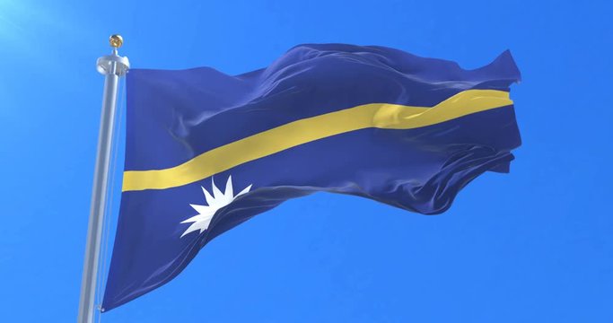 Flag of Nauru waving at wind in slow in blue sky, loop