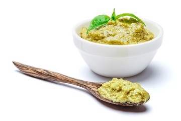 Pesto Sauce with Basil and wooden spoon on White Background Studio shot