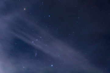 The constellation of Orion in the night sky by the light of the moon.