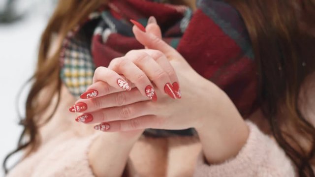 close up shot of the woman's hands, the lady is frozen and trying to keep warm, she rubs her palms against each other