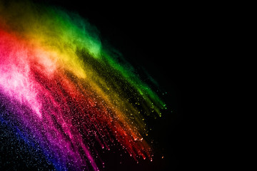abstract colored dust explosion on a black background.abstract powder splatted background,Freeze motion of color powder exploding/throwing color powder, multicolored glitter texture.