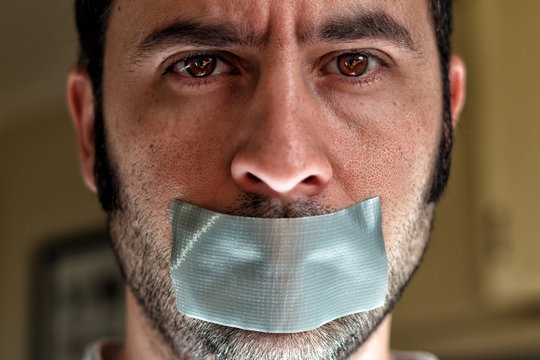 Close up portrait of a man with duct tape over his mouth Stock Photo |  Adobe Stock