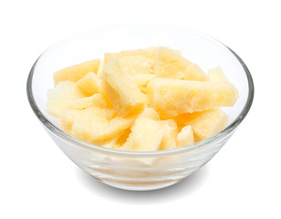 Parmesan cheese pieces in glass bowl on white background