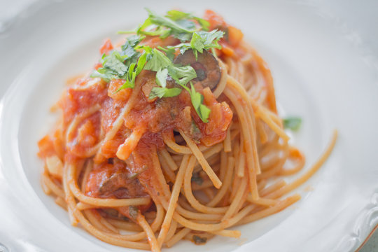 A plate of puttanesca spaghetti.