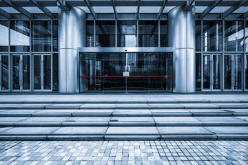 empty pavement front of the modern office entrance.