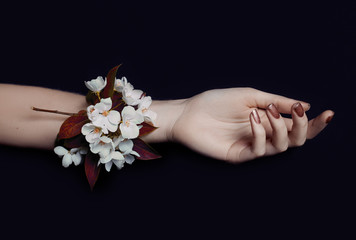 Fashion art hand woman in summer time and flowers on her hand with bright contrasting makeup. Creative beauty photo hand girls sitting at table on contrasting background with colored shadows. Skincare