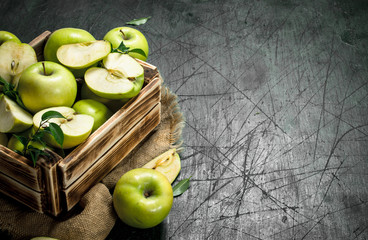 Green apples in an old box.