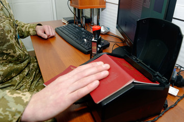 Scanning a Russian passport for border control at the Ukrainian checkpoint