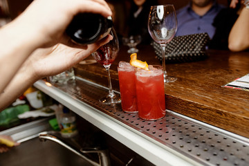 The bartender makes a cocktail