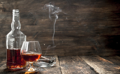 French cognac with a smoking cigar.