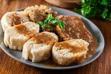 Pork loin in gravy with bread dumplings and sauerkraut
