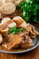 Pork loin in gravy with bread dumplings and sauerkraut
