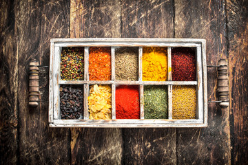 Different spices and herbs in a box.