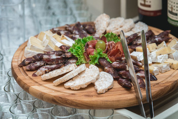 Mix cheese on wooden board with meat and bread