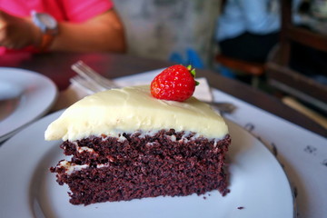 Chocolate cake with cream cheese topping and strawberry