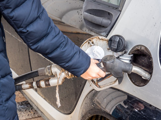 Frau füllt ihr Auto mit Benzin auf