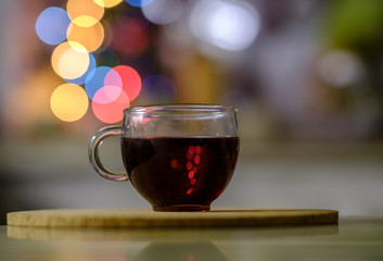 tea in glass Cup on a background of colored lights