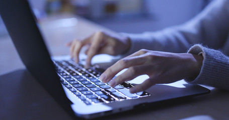 Woman use of notebook at home in the evening