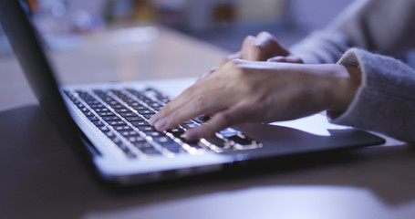 Woman use of notebook at home in the evening