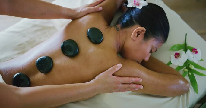 Woman relaxing enjoying hot stone massage at the spa