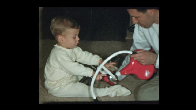 1954 Father teaches son to use tools and repair tricycle