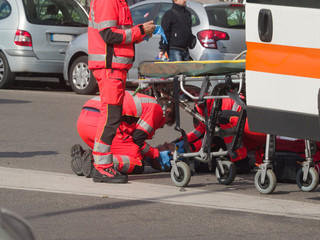 paramedics rescued a guy who had a motorcycle accident with his motorcycle, before loading it on the ambulance