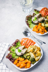 Steamed fish steak and galic butter  roasted vegetables. Top view, copy space.