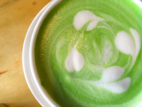 Closeup hot green tea and milk is delicious.