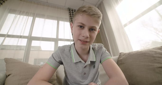 Happy funny teenager having a video chat. Point of view of the computer screen. 4K