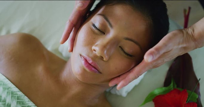Woman relaxing recieving facial treatment at the spa