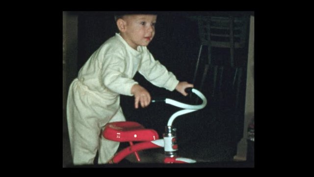 1954 Cute baby boy on classic antique red tricycle