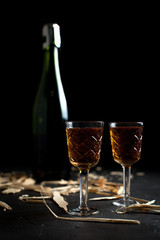 bottle and glasses with wine on a dark background