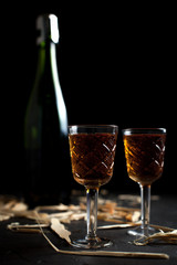 bottle and glasses with wine on a dark background
