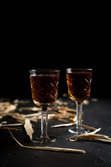 two glasses with wine on a dark background