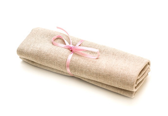 Cloth bundle, tied with a pink ribbon, isolated on white