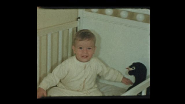 1954 Portrait and cute little boy who learned how to climb into his crib