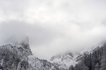 Snowy peaks and mountain ranges and with clouds and mist in winter in Austrian Alps in Stubai