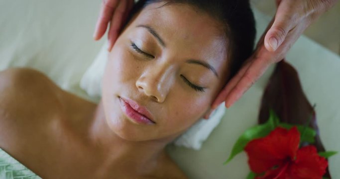 Woman relaxing receiving facial treatment at the spa