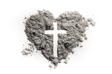 Cross or crucifix in heart symbol made of ash