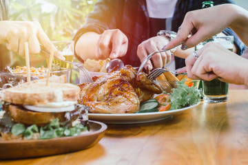 Two asian women and one men Eating food on table in holiday