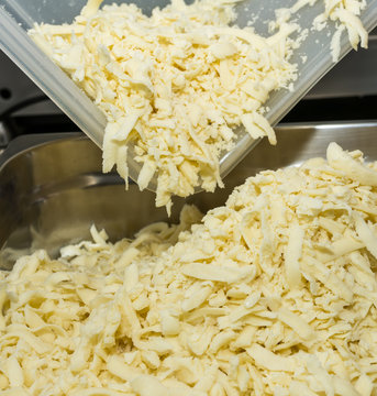 cheese cut for pizza preparation. Food, italian cuisine and cooking concept.