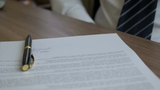 Bribery and corruption concept, bribe in the form of dollar bills, Businessman takes a  money while making deal to agreement a real estate contract and financial corporate.