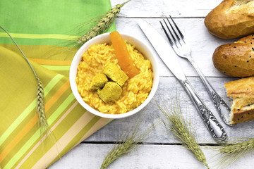 homemade arabic food basmati rice with chicken and carrot in white glass bowl, baguette bread