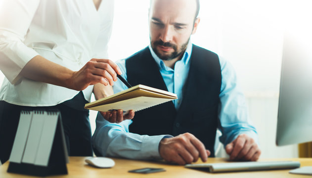 Bearded young businessman working on office. Director man thinking looking in monitor computer. Managers meeting. Idea, alalyze marketing plans. Workplace concept, project with colleague