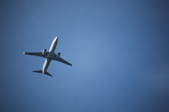 Leiden, Zuid-Holland/The Netherlands - October 28th 2017: lone white airplaine flying in the sky on a clear blue day