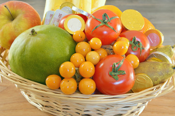 a fruits are the treasures of nature. fruits and chocolate coins in the basket 