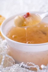 Tremella soup. Closeup of tremella, lotus and wolf-berry  in a spoon.