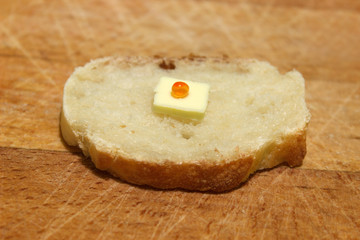 Sandwich for poor people who have not a money with small piece of butter and only one grain of red caviar