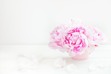 Fresh bunch of pink peonies on light background