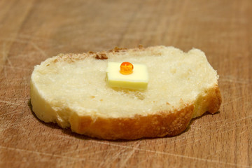 Sandwich for poor people who have not a money with small piece of butter and only one grain of red caviar